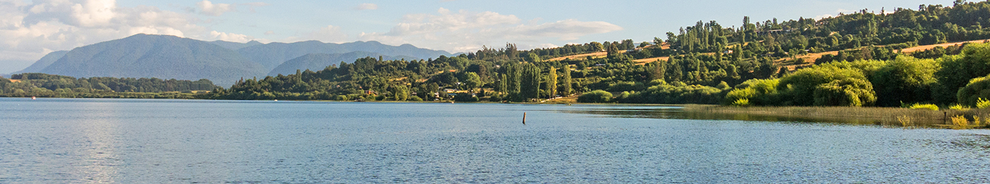 Serene panorama of the calm waters of Panguipulli Lake, from the